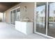 Outdoor kitchen with granite countertop, sink, and sliding glass doors for indoor/outdoor living at 14126 Fox Glove St, Winter Garden, FL 34787