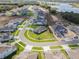 Aerial view of a Primary-planned community featuring houses by a lake, green spaces, and winding streets at 16033 Barkly Ridge Ct, Winter Garden, FL 34787