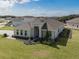 A high-angle view of a well-kept home, nestled among manicured lawns and other residences in a peaceful neighborhood at 16033 Barkly Ridge Ct, Winter Garden, FL 34787