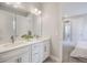 Bright bathroom with double vanity, quartz countertop, and access to bedroom at 16033 Barkly Ridge Ct, Winter Garden, FL 34787