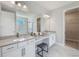 Bright bathroom featuring double vanity, a large mirror, and an open doorway into the walk-in closet at 16033 Barkly Ridge Ct, Winter Garden, FL 34787