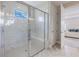 Luxurious bathroom with a tiled walk-in shower, glass doors, and modern fixtures creating a spa-like experience at 16033 Barkly Ridge Ct, Winter Garden, FL 34787
