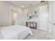 Bright bedroom featuring a white comforter, neutral decor, and doorway leading into another room at 16033 Barkly Ridge Ct, Winter Garden, FL 34787