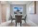 Bright dining nook with a glass table and upholstered chairs positioned by a window with scenic views at 16033 Barkly Ridge Ct, Winter Garden, FL 34787