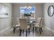 Elegant dining area with a glass-top table, tufted chairs, modern chandelier, and tasteful decor, with natural light at 16033 Barkly Ridge Ct, Winter Garden, FL 34787