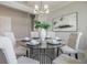 Tastefully decorated dining area featuring a round glass table, upholstered chairs, and stylish lighting fixture at 16033 Barkly Ridge Ct, Winter Garden, FL 34787