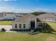 Charming single-story home with a well-manicured lawn and inviting front entrance with blue skies above at 16033 Barkly Ridge Ct, Winter Garden, FL 34787