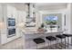 Beautiful kitchen with white cabinets, stainless steel appliances, backsplash, and a large center island with seating at 16033 Barkly Ridge Ct, Winter Garden, FL 34787