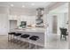 Open kitchen featuring white cabinets, stainless appliances, a center island with seating, and modern fixtures at 16033 Barkly Ridge Ct, Winter Garden, FL 34787