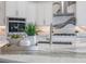 Close up of a kitchen island featuring stainless steel appliances, a stone countertop, and a sink at 16033 Barkly Ridge Ct, Winter Garden, FL 34787
