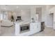 Open floor plan showcasing kitchen island with microwave and sink, flowing into living room with ample seating at 16033 Barkly Ridge Ct, Winter Garden, FL 34787