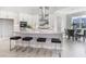 Open concept kitchen with large island, seating, stainless steel appliances, and an eat-in dining area at 16033 Barkly Ridge Ct, Winter Garden, FL 34787
