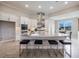 Bright kitchen featuring a large center island with seating, stainless steel appliances, and white cabinets at 16033 Barkly Ridge Ct, Winter Garden, FL 34787