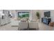 Bright living room boasts modern furniture, neutral tones, and an open floorplan with a large sliding glass door at 16033 Barkly Ridge Ct, Winter Garden, FL 34787