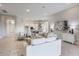 Expansive living room with modern furniture and decor flowing seamlessly into a kitchen with bar top seating at 16033 Barkly Ridge Ct, Winter Garden, FL 34787