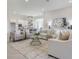 Airy living area featuring modern décor, a stylish rug, and an open layout that flows into the adjacent kitchen at 16033 Barkly Ridge Ct, Winter Garden, FL 34787