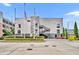 Two story commercial building with exterior staircase, flags and nicely trimmed hedges in urban setting at 62 W Colonial Dr # 303, Orlando, FL 32801