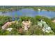 Expansive property with a luxurious home, surrounded by lush landscaping and a large lake at 6324 Deacon Cir, Windermere, FL 34786