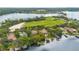 Lakeside neighborhood showcasing a golf course and luxurious homes with pools and boat docks at 6324 Deacon Cir, Windermere, FL 34786