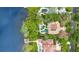 Luxury lakefront property featuring a large pool, a manicured lawn, and a private boat dock at 6324 Deacon Cir, Windermere, FL 34786