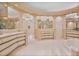Spacious bathroom featuring custom cabinets, sinks, mirrors, and a luxurious bathtub at 6324 Deacon Cir, Windermere, FL 34786