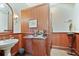 The bathroom features a uniquely decorated sink and vanity, separated from the water closet by a wood partition at 6324 Deacon Cir, Windermere, FL 34786