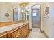 Bathroom featuring a wood vanity with a tile countertop and a shower with a glass door at 6324 Deacon Cir, Windermere, FL 34786