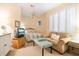 A comfy bedroom features neutral walls, carpeted floors, shutters on the windows, a sofa, and a ceiling fan at 6324 Deacon Cir, Windermere, FL 34786