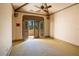 Neutral bedroom with doors opening to a patio with an outdoor view of palms and lush foliage at 6324 Deacon Cir, Windermere, FL 34786
