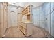 Large walk-in closet featuring custom-built cabinetry and unique curved glass accents at 6324 Deacon Cir, Windermere, FL 34786