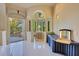 Bright dressing room featuring a vanity, arched windows with scenic views, and an exterior door to the patio at 6324 Deacon Cir, Windermere, FL 34786