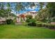 Stunning home featuring a circular driveway, lush landscaping, and a grand entrance with a covered portico at 6324 Deacon Cir, Windermere, FL 34786