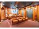 A home theater features leather recliners, a large projector screen, and decorative walls at 6324 Deacon Cir, Windermere, FL 34786