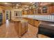 A kitchen features custom cabinetry, granite countertops, and terra cotta tile at 6324 Deacon Cir, Windermere, FL 34786