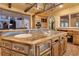 A kitchen features a large island with granite countertops, sink, and stove top at 6324 Deacon Cir, Windermere, FL 34786