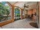 An outdoor patio features tile flooring, several seating options, and views of the pool and outdoor landscape at 6324 Deacon Cir, Windermere, FL 34786
