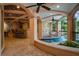 An outdoor spa area features a jacuzzi, bar, and mosaic details with several seating options, with a pool on the side at 6324 Deacon Cir, Windermere, FL 34786