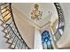 Dramatic view of the curved staircase and high ceilings with ornate chandelier at 6324 Deacon Cir, Windermere, FL 34786