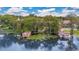 Picturesque waterfront view featuring boathouses, lush greenery, and serene water lilies at 6324 Deacon Cir, Windermere, FL 34786