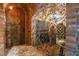 A wine cellar features brick walls, wrought iron, arched doorway, and wine racks at 6324 Deacon Cir, Windermere, FL 34786