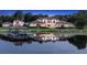 Stunning lakefront home with private dock and tranquil setting at dusk at 1965 Lake Markham Preserve Trl, Sanford, FL 32771