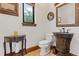 Elegant powder room features a unique sink, decorative mirror, and stylish accents at 1965 Lake Markham Preserve Trl, Sanford, FL 32771