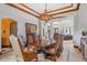 Formal dining room with wood floors, wood trim ceiling, and designer chandelier at 1965 Lake Markham Preserve Trl, Sanford, FL 32771