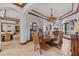 Elegant dining room features wood trim ceiling, designer chandelier, and travertine floors at 1965 Lake Markham Preserve Trl, Sanford, FL 32771