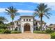 Mediterranean home with red tile roof, a grand entrance, mature palm trees and paved driveway at 1965 Lake Markham Preserve Trl, Sanford, FL 32771