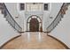 Elegant grand foyer with dual staircase, tile flooring, and a large wooden entry door at 1965 Lake Markham Preserve Trl, Sanford, FL 32771