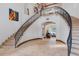 Grand foyer with a curved staircase, iron railings, and an open view to the living room at 1965 Lake Markham Preserve Trl, Sanford, FL 32771