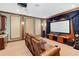 Cozy home theater with leather seating, a large screen, and custom woodwork at 1965 Lake Markham Preserve Trl, Sanford, FL 32771