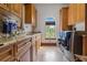 Well-equipped laundry room featuring granite counters, custom cabinets, and modern appliances at 1965 Lake Markham Preserve Trl, Sanford, FL 32771