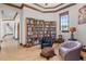 Cozy library with floor-to-ceiling bookshelves, comfortable seating, and an inviting atmosphere at 1965 Lake Markham Preserve Trl, Sanford, FL 32771